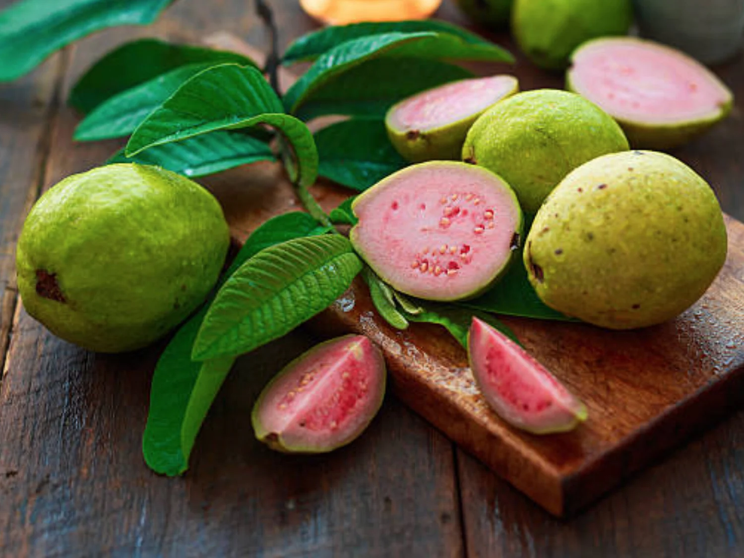 Sliced pink guava from Indonesia on a wooden board