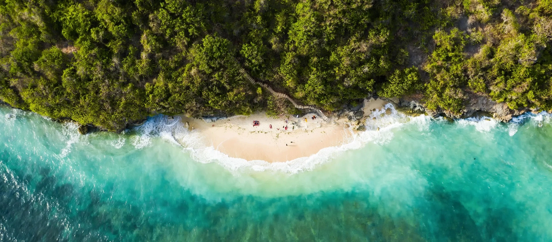 Aerial view of a hidden Bali beach with turquoise water